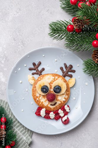 Funny food for kids. Reindeer pancake for  breakfast photo