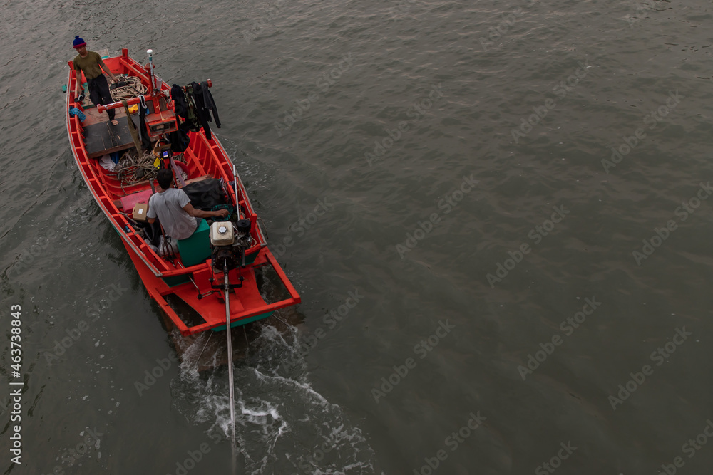 Obraz premium Phetchaburi,Thailand - Mar 15, 2020 : The fisherman and wooden fishing boat used as a vehicle for finding fish in the sea. Selective focus.
