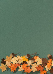 flat lay with colorful handmade paper foliage arranged on yellow background