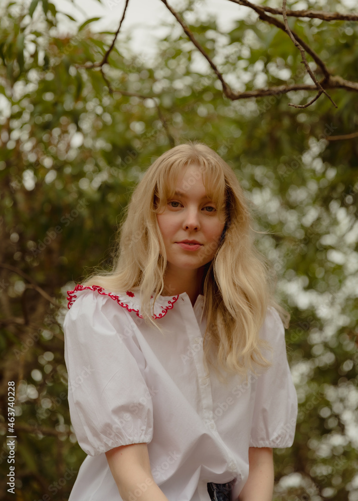 Blonde woman sitting in a tree Blonde woman sitting in a tree