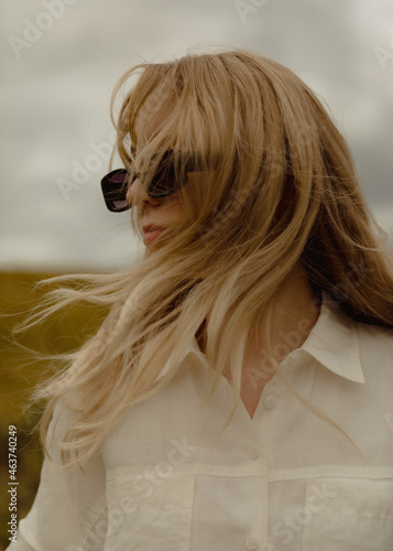 Young blonde woman wearing sunglasses