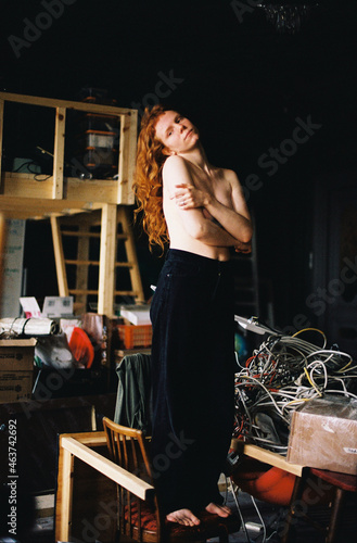 Topless girl with long red hair posing in messy photo