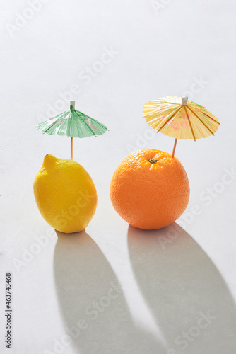 orange and lemon with mini umbrellas photo