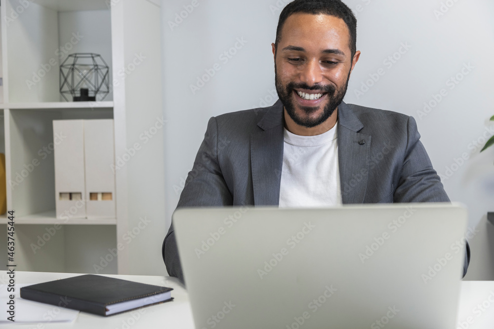 Young african american man working using his laptop. Smiling businessman on online business meeting. Copy space. Young african american man working using his laptop. Smiling businessman on online business meeting. Copy space.