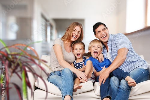 Family with little child resting in living room
