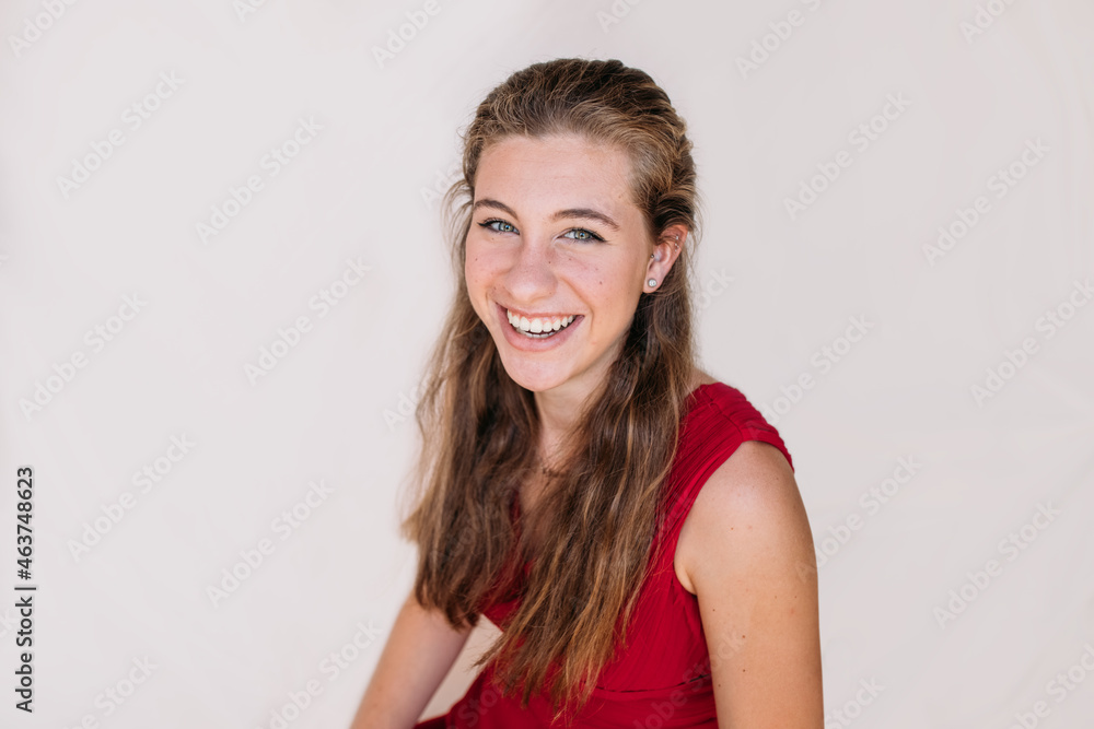 Smiling woman in casual outfit in light room