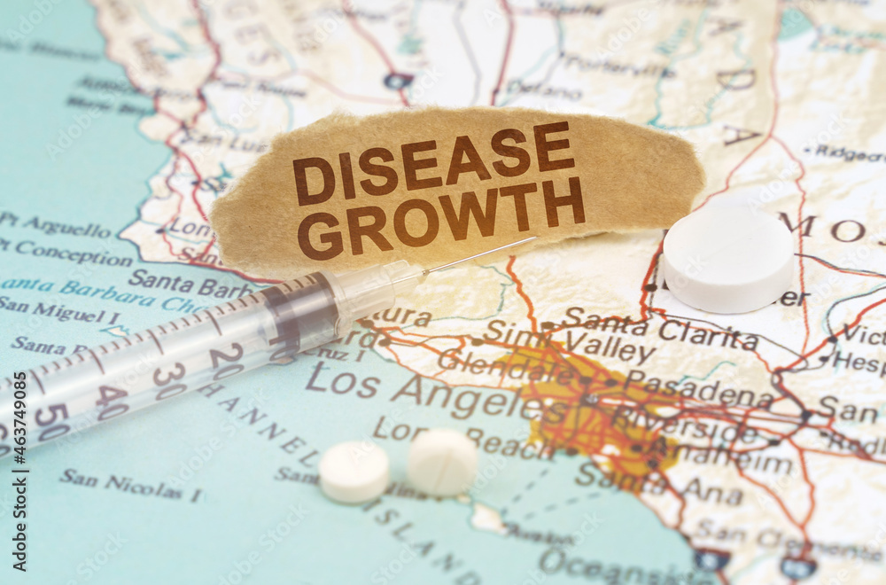 On a map of California lies a syringe, pills and paper with the inscription - disease growth