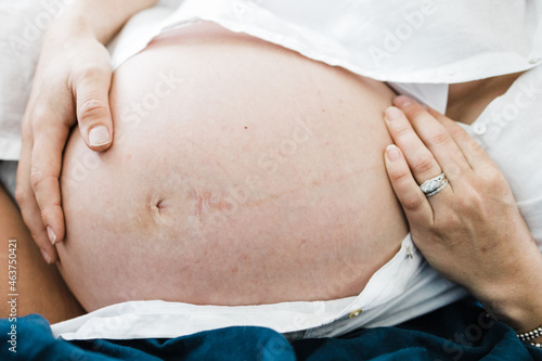 Woman caresses her baby bump