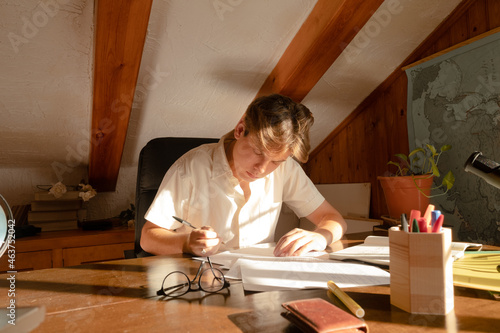 Pensive student sitting writting