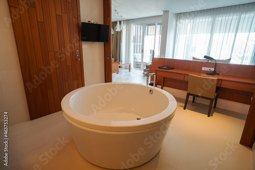 Hua Hin Thailand - selective focus white luxury bathtub in open bathroom in a hotel bedroom with white cotton mat