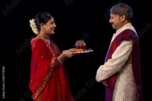 Indian husband and wife together celebrating Karva Chauth photo