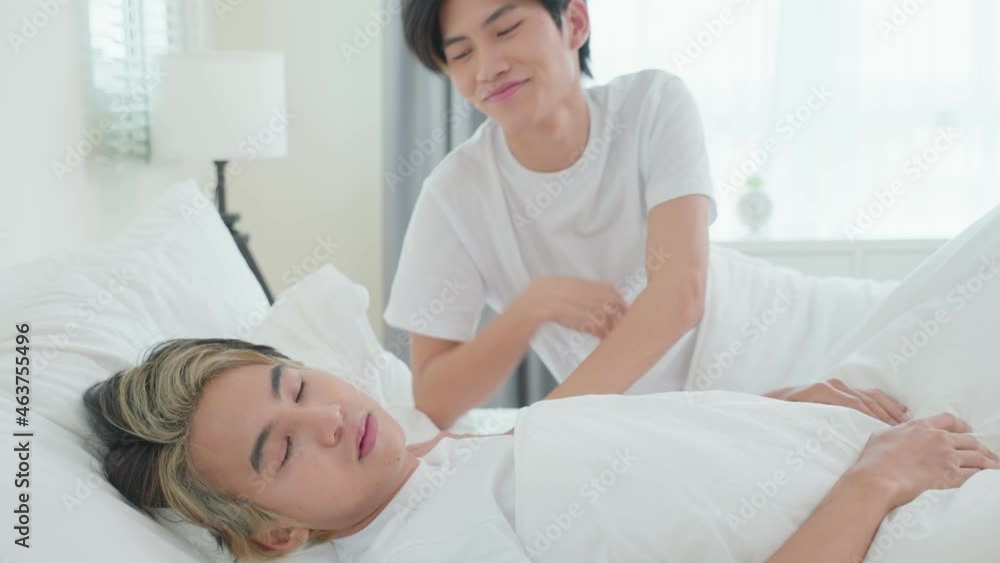 Asian attractive gay kiss boyfriend's forehead to wake up from sleep. Asian attractive gay kiss boyfriend's forehead to wake up from sleep.