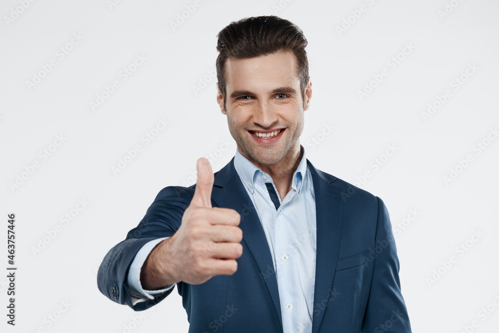 Smiling european business man showing thumb up Smiling european business man showing thumb up