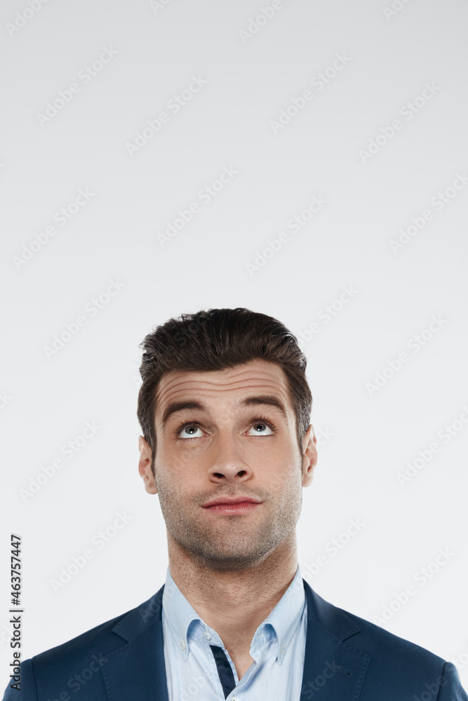 Young focused european business man looking up Young focused european business man looking up