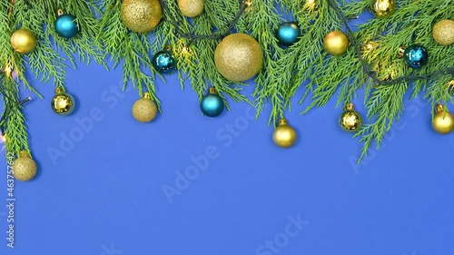 Christmas fir twigs appear on royal blue theme and gold and blue ornaments decorate it. Stop motion