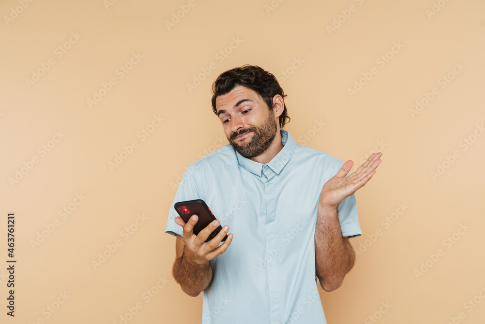 White bristle man wearing shirt gesturing and using mobile phone White bristle man wearing shirt gesturing and using mobile phone