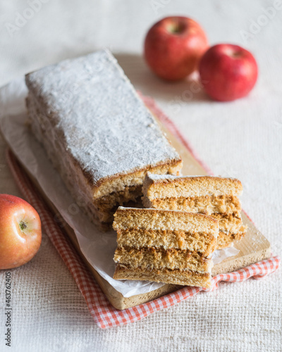 Layered russian apple pastille marshmallow on paper on a board, red apples in background. Selective focus. Vegan food