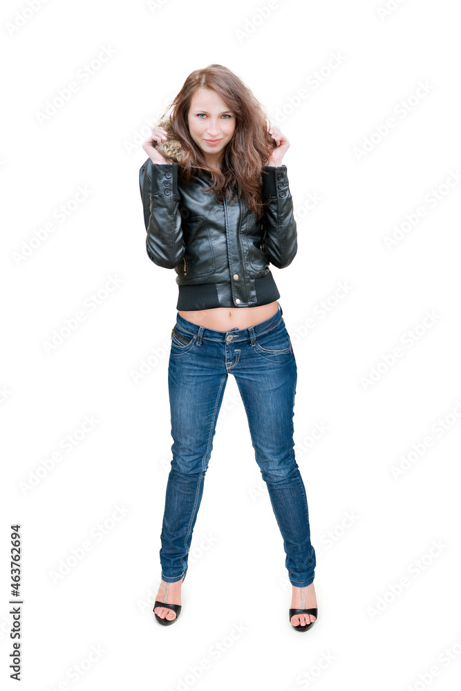 Full length portrait of a slim young woman wearing a leather jacket, blue jeans and high heels, isolated in front of white studio background Full length portrait of a slim young woman wearing a leather jacket, blue jeans and high heels, isolated in front of white studio background