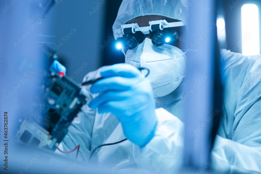 African-American scientist works in a modern scientific laboratory for the research and development of microelectronics and processors. Manufacturing worker uses computer technology and equipment. African-American scientist works in a modern scientific laboratory for the research and development of microelectronics and processors. Manufacturing worker uses computer technology and equipment.