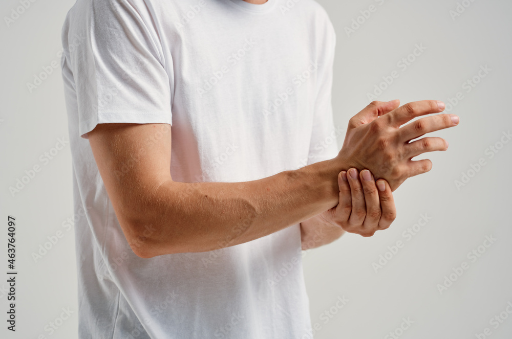 man in white t-shirt joint pain hand health problems man in white t-shirt joint pain hand health problems