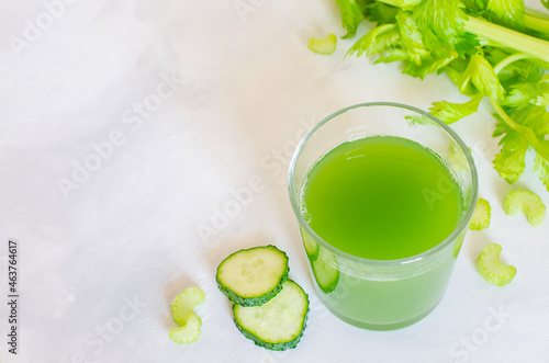 Fresh celery and cucumber juice. Green healthy drink in a glass on a white background. Detox diet, pure organic food, with vegetables