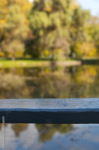 wooden table in front of the lake at sunset light. Ready to showcase products 