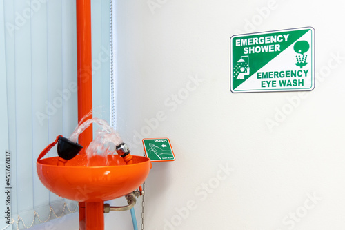 Emergency eyewash stations in the safety of workers with water flowing in laboratory or manufacturing facility. photo