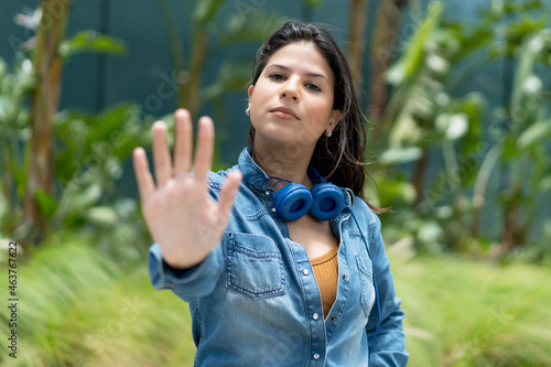 Caucasian female young adult gesturing stop and distance photo