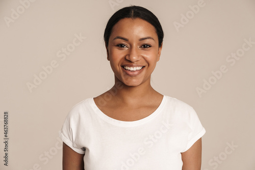 Young black woman wearing t-shirt smiling and looking at camera © Drobot Dean