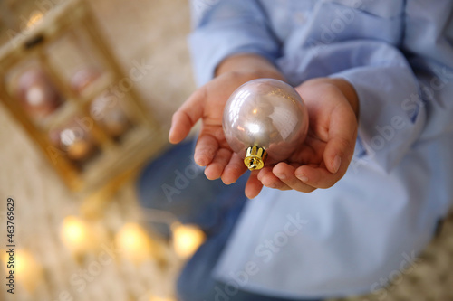 Christmas ball in the palms of a child