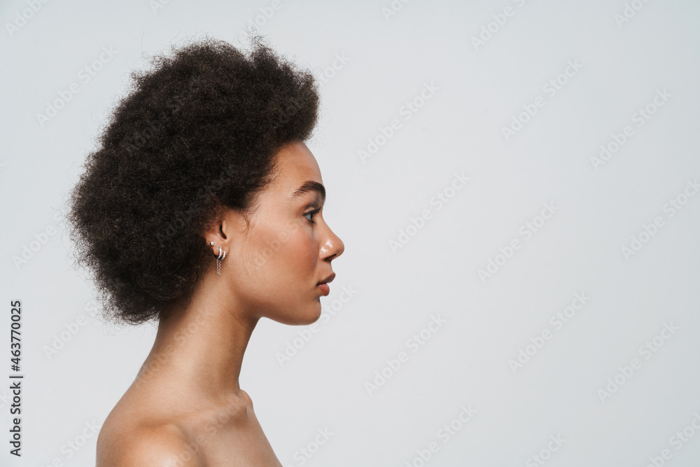 Black shirtless woman looking aside while posing in profile Black shirtless woman looking aside while posing in profile