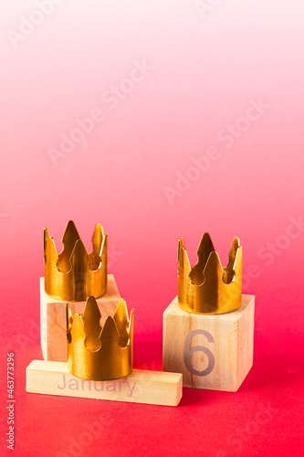 Three gold crowns on red background with 6 Junuary date for Dia de Reyes Magos day ( Three Wise Men) or Epiphany day