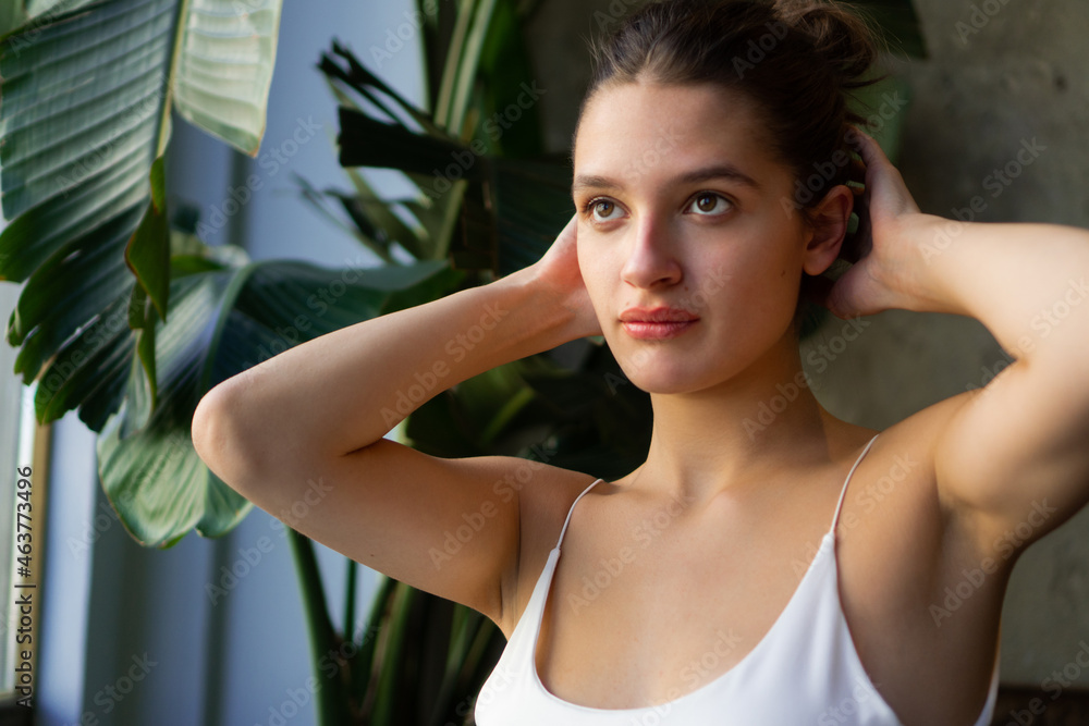 Close-up portrait of a beautiful young caucasian woman with natural brown hair. Close-up portrait of a beautiful young caucasian woman with natural brown hair.