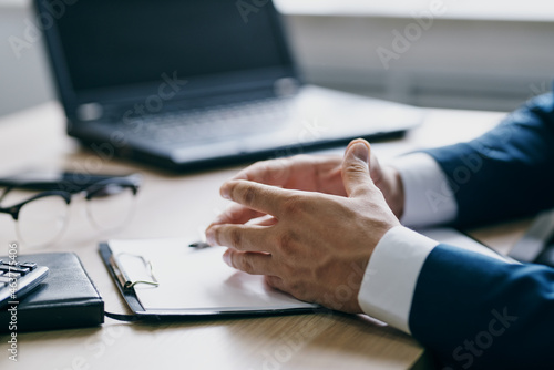 manager sitting at a desk in front of a laptop finance professional