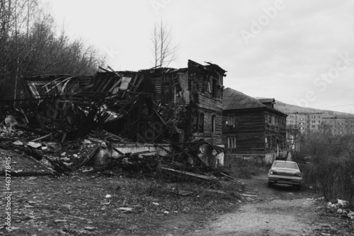 Abandoned city. Ghost town. Ruined wooden houses, broken log cabin