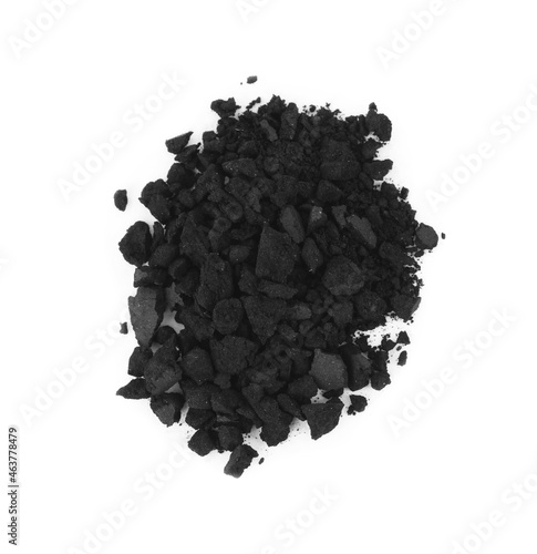 Pile of crushed activated charcoal pills on white background, top view. Potent sorbent