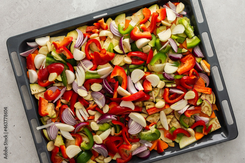 Fresh assorted autumn cut vegetables on a baking sheet ready to roast in the oven