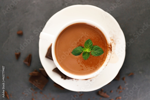 hot chocolate with mint leaves on dark background.