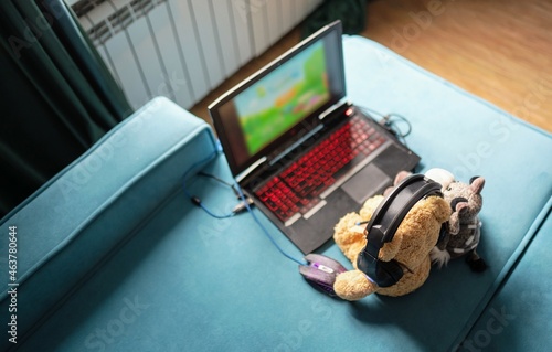 toys playing in digital game on laptop. selective focus photo