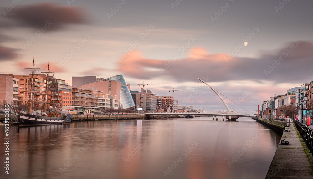 Dublin Docklands Ireland in the Liffey River at sunset, orange sky