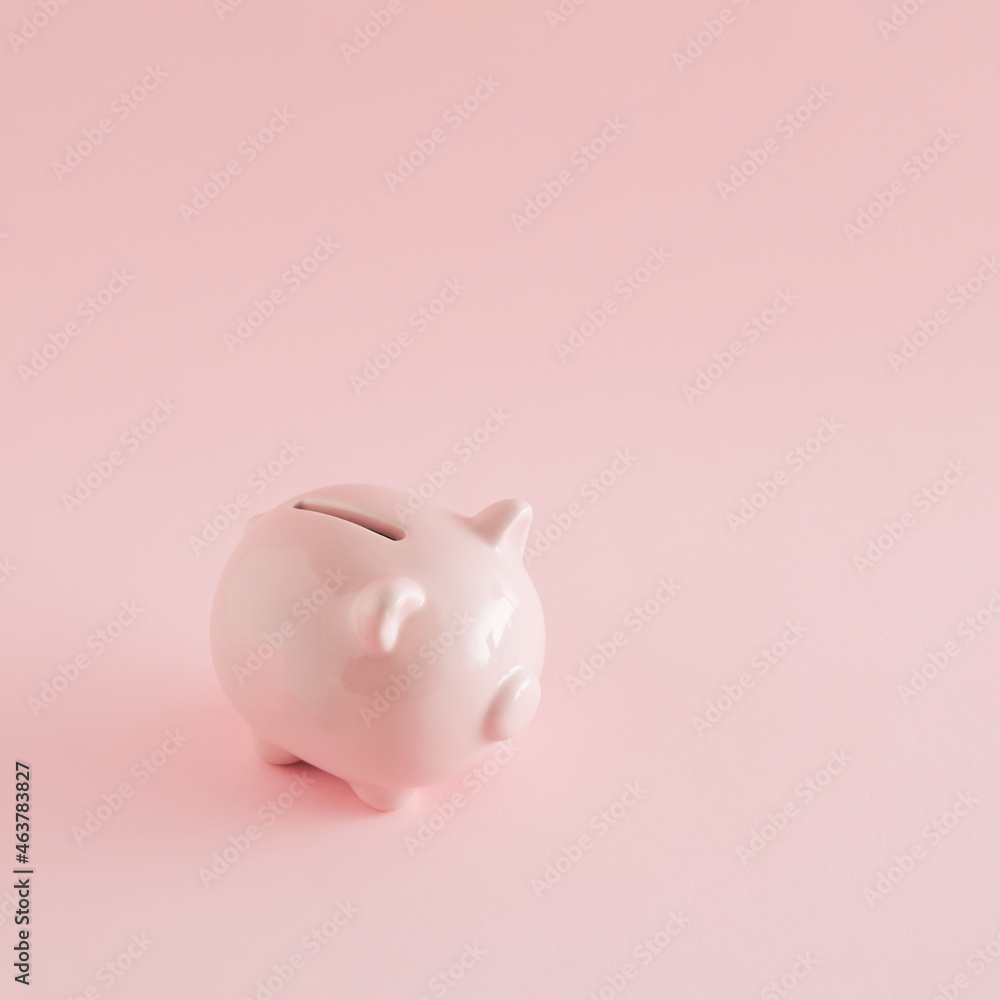 Pink piggy bank on a pink background. Minimal savings concept. International savings day inspiration.
