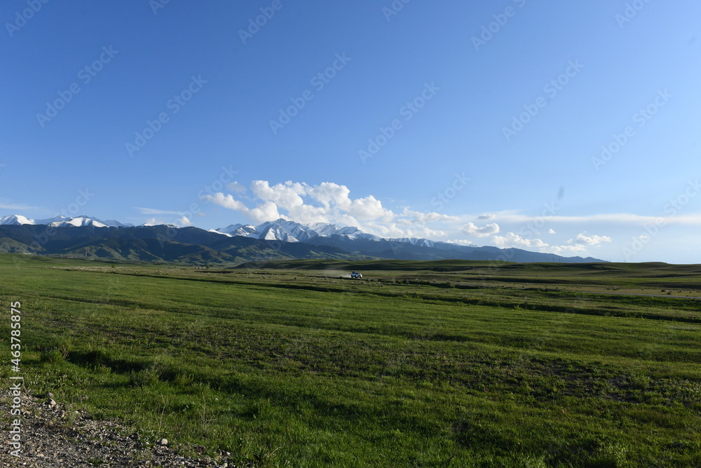 Fototapeta premium Mountain landscape with clouds and road, Kazakhstan, Almaty region
