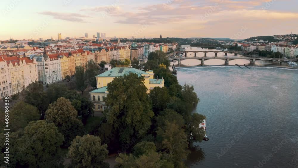 Beautiful Buildings Of Zofín Palace And Manes Exhibition Hall At The Waterfront Of Vltava River In Prague. ascending drone shot Beautiful Buildings Of Zofín Palace And Manes Exhibition Hall At The Waterfront Of Vltava River In Prague. ascending drone shot