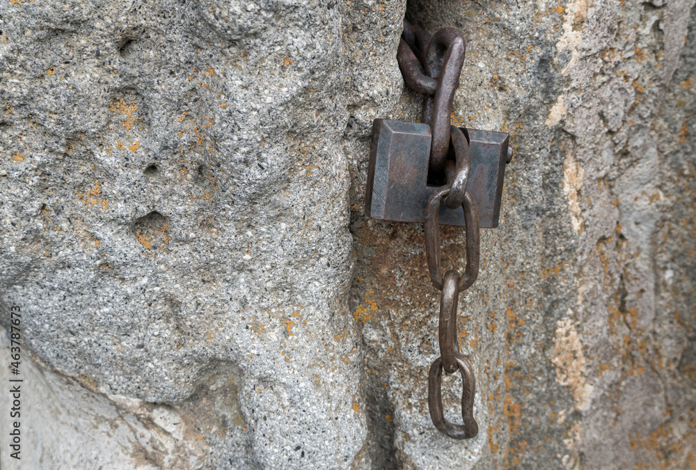 old iron castle on a stone wall. iron chain old iron castle on a stone wall. iron chain