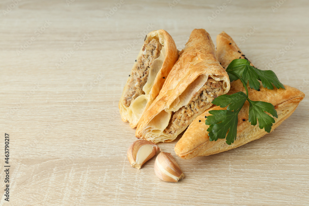 Golden samsa with ingredients on wooden background Golden samsa with ingredients on wooden background