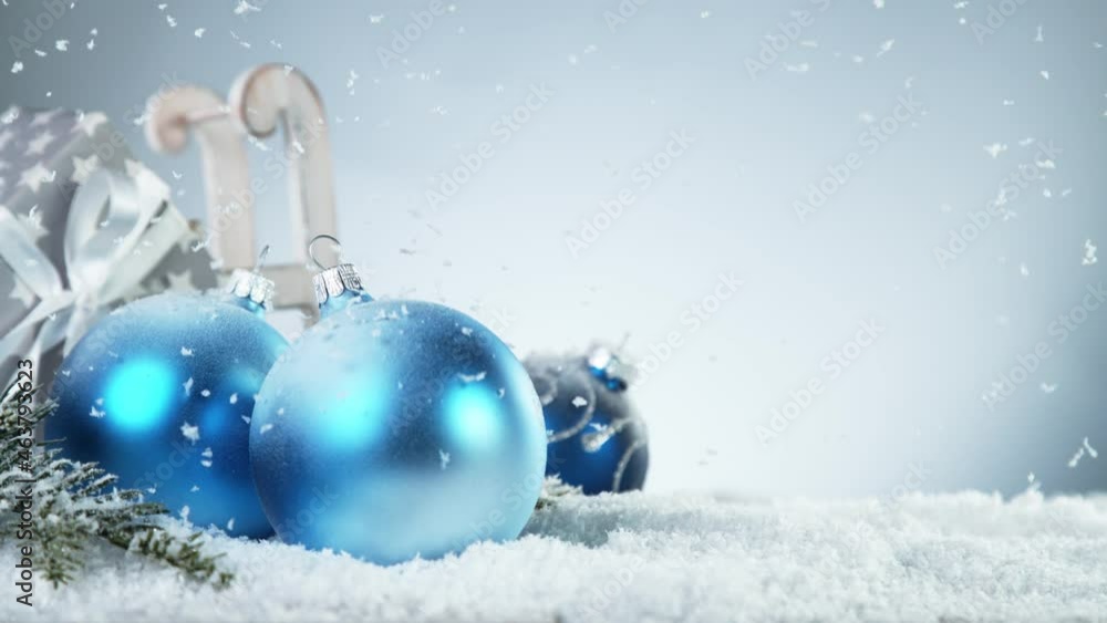 Super slow motion of falling snow with christmas glass balls. Filmed on high speed cinema camera, 1000 fps. Super slow motion of falling snow with christmas glass balls. Filmed on high speed cinema camera, 1000 fps.