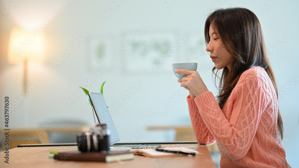 Pretty young woman feels calm and relaxed after drinking hot cappuccino Pretty young woman feels calm and relaxed after drinking hot cappuccino