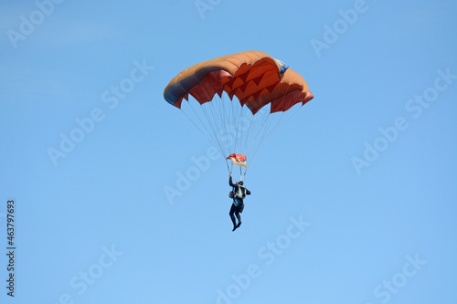 Man skydiver parachuting down to the ground
