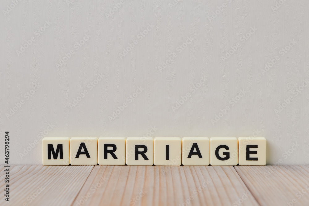 Square letters with text MARRIAGE on wooden table Square letters with text MARRIAGE on wooden table