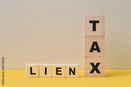 Wooden blocks with the words TAX LIEN. Business concept. photo